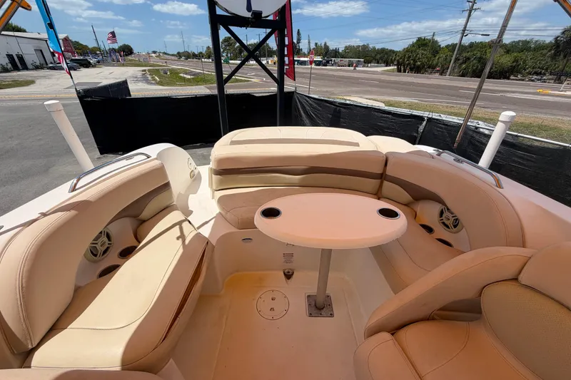 Slide: The Image of 2006 Chaparral Sunesta 236 boat interior with beige seating and round table. - 77