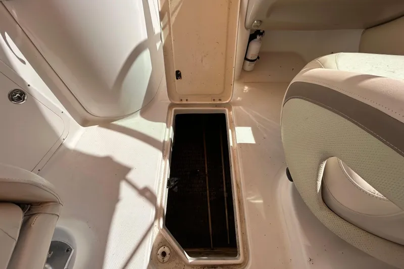 Slide: The Image of 2006 Chaparral Sunesta 236 boat interior with open storage compartment. - 24