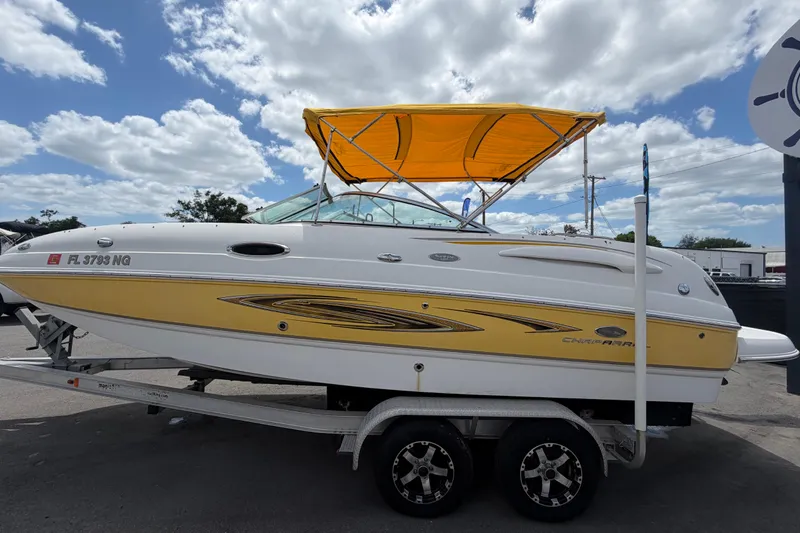 Slide: The Image of 2006 Chaparral Sunesta 236 boat with yellow canopy on trailer under cloudy sky. - 9