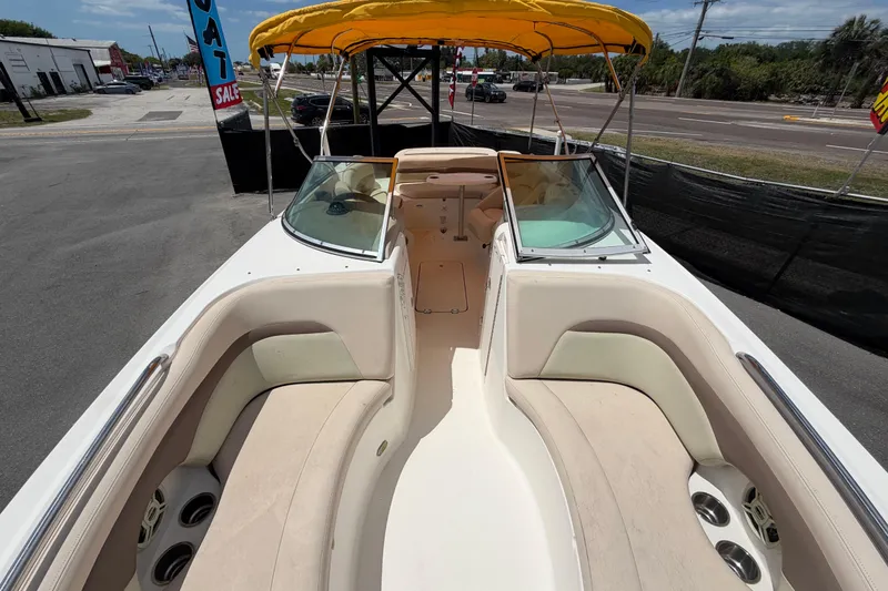 Slide: The Image of 2006 Chaparral Sunesta 236 boat interior with yellow canopy and seating area. - 70