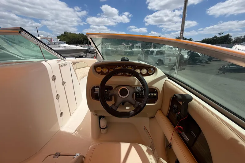 Slide: The Image of 2006 Chaparral Sunesta 236 boat cockpit with steering wheel and dashboard controls. - 28