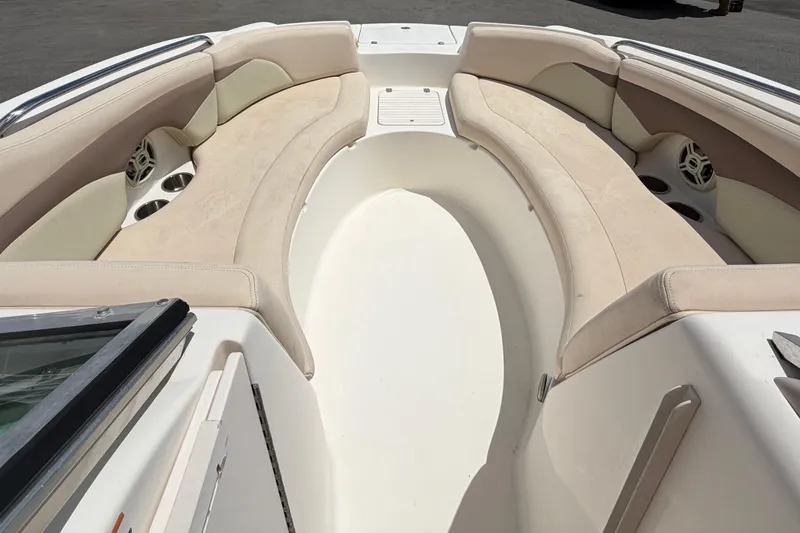 Slide: The Image of 2006 Chaparral Sunesta 236 boat interior with beige seating and cup holders. - 54