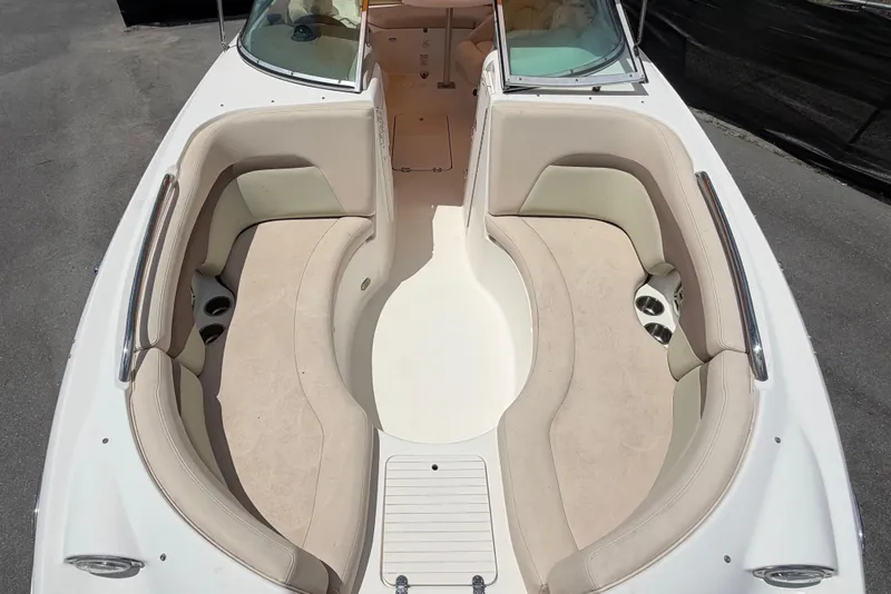 Slide: The Image of 2006 Chaparral Sunesta 236 boat interior with beige seating and cup holders. - 68
