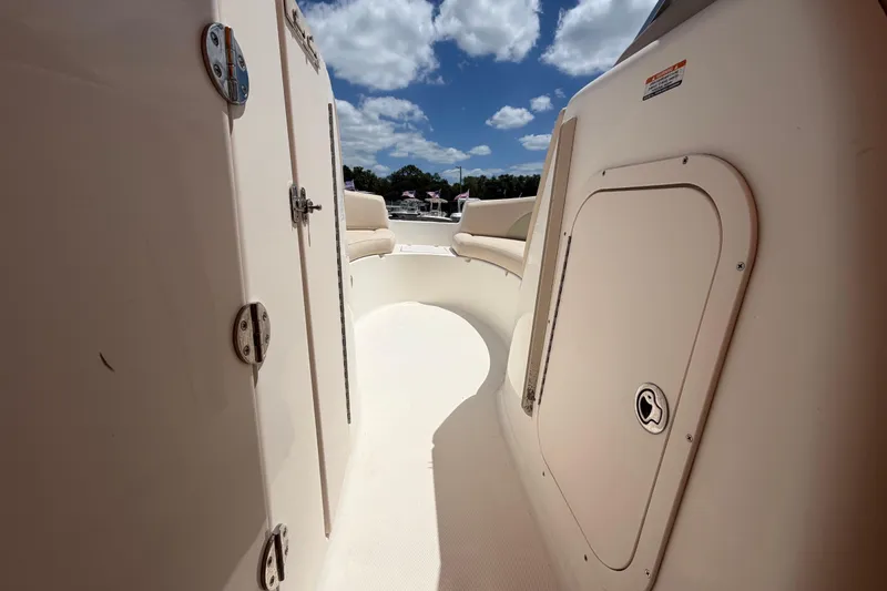 Slide: The Image of 2006 Chaparral Sunesta 236 interior view with seating and storage compartments under a blue sky. - 51