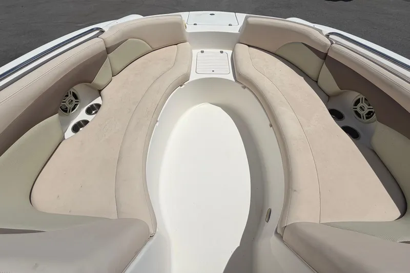 Slide: The Image of 2006 Chaparral Sunesta 236 boat interior with beige seating and cup holders. - 55