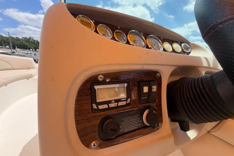 Slide: The Image of Dashboard of a 2006 Chaparral Sunesta 236 boat with gauges and controls. - 33