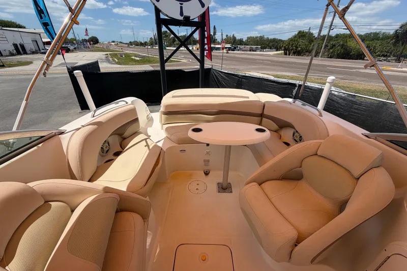 Slide: The Image of 2006 Chaparral Sunesta 236 boat interior with beige seating and round table. - 76