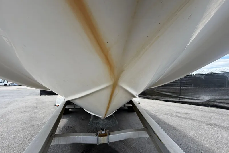 Slide: The Image of 2006 Chaparral Sunesta 236 boat hull on trailer, showing underside and rust streaks. - 14
