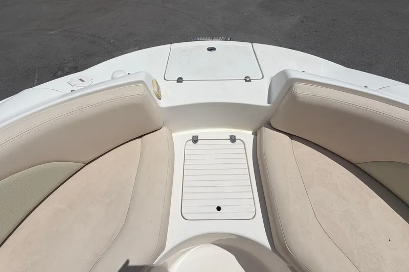 Slide: The Image of 2006 Chaparral Sunesta 236 boat interior with beige seating and storage compartment. - 61
