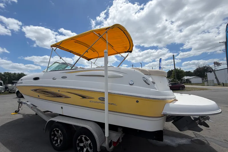 Slide: The Image of 2006 Chaparral Sunesta 236 boat with yellow canopy on trailer under cloudy sky. - 8