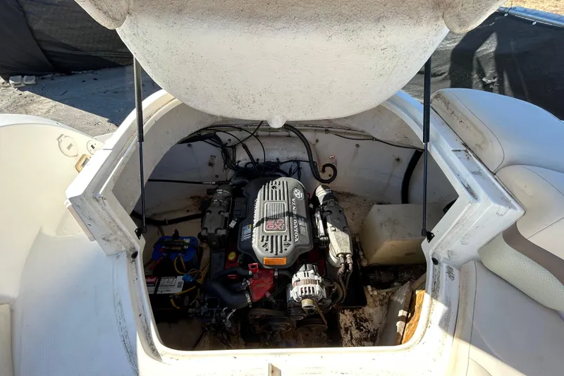 Slide: The Image of 2006 Chaparral Sunesta 236 boat engine compartment with visible engine components. - 83