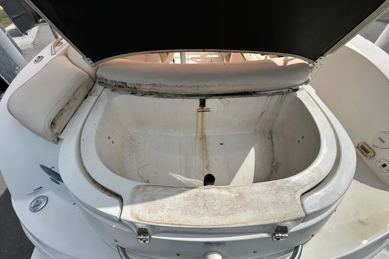Slide: The Image of 2006 Chaparral Sunesta 236 boat storage compartment, showing wear and dirt. - 18