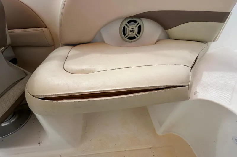 Slide: The Image of 2006 Chaparral Sunesta 236 boat seat with beige upholstery and built-in speaker. - 78