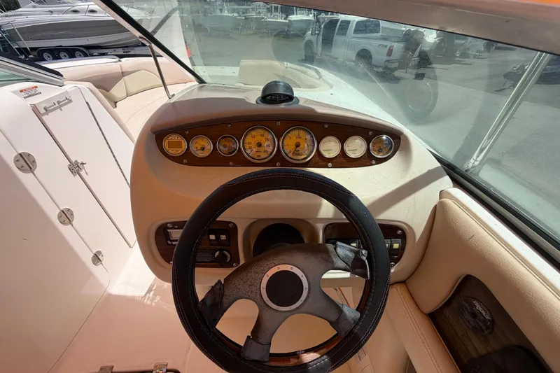 Slide: The Image of 2006 Chaparral Sunesta 236 boat dashboard with steering wheel and gauges. - 29