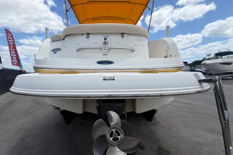 Slide: The Image of 2006 Chaparral Sunesta 236 boat with yellow canopy, rear view showing propeller and swim platform. - 4