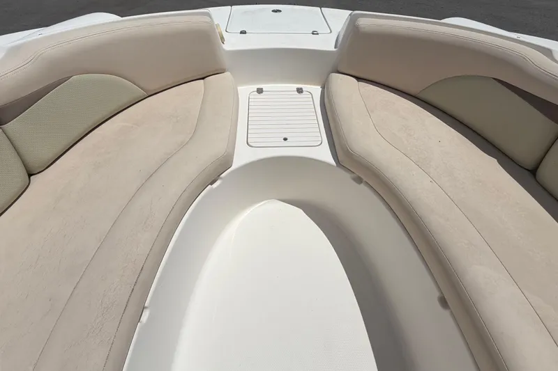 Slide: The Image of 2006 Chaparral Sunesta 236 boat interior with beige seating and storage compartment. - 60