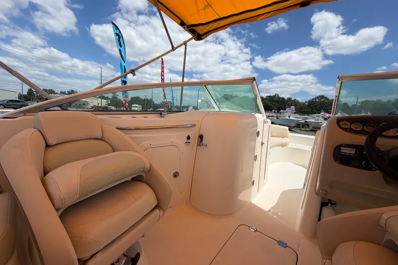 Slide: The Image of 2006 Chaparral Sunesta 236 boat interior with beige seating and yellow canopy. - 37