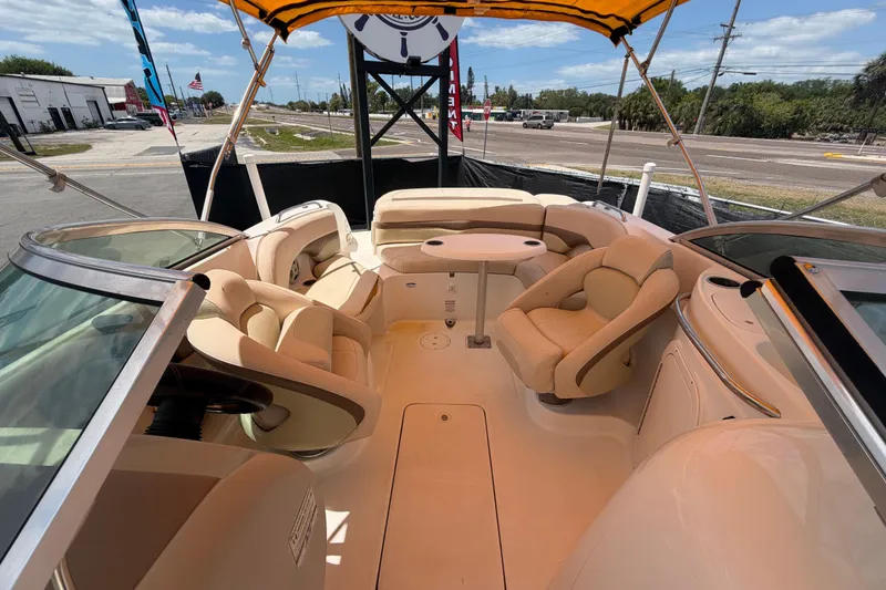 Slide: The Image of 2006 Chaparral Sunesta 236 boat interior with beige seating and canopy. - 74