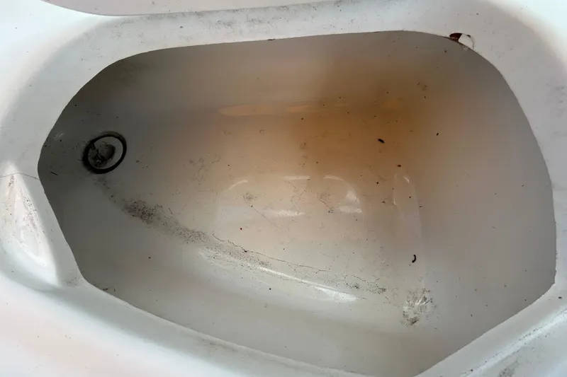 Slide: The Image of 2006 Chaparral Sunesta 236 boat compartment, showing wear and dirt accumulation. - 46