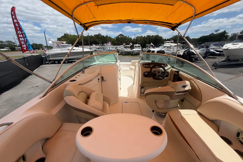 Slide: The Image of 2006 Chaparral Sunesta 236 boat interior with yellow canopy and seating area. - 21