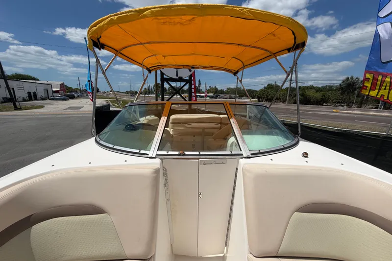 Slide: The Image of 2006 Chaparral Sunesta 236 boat with yellow canopy, parked outdoors under blue sky. - 72