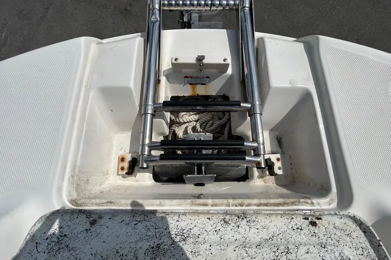 Slide: The Image of 2006 Chaparral Sunesta 236 boat ladder and storage compartment with rope. - 67