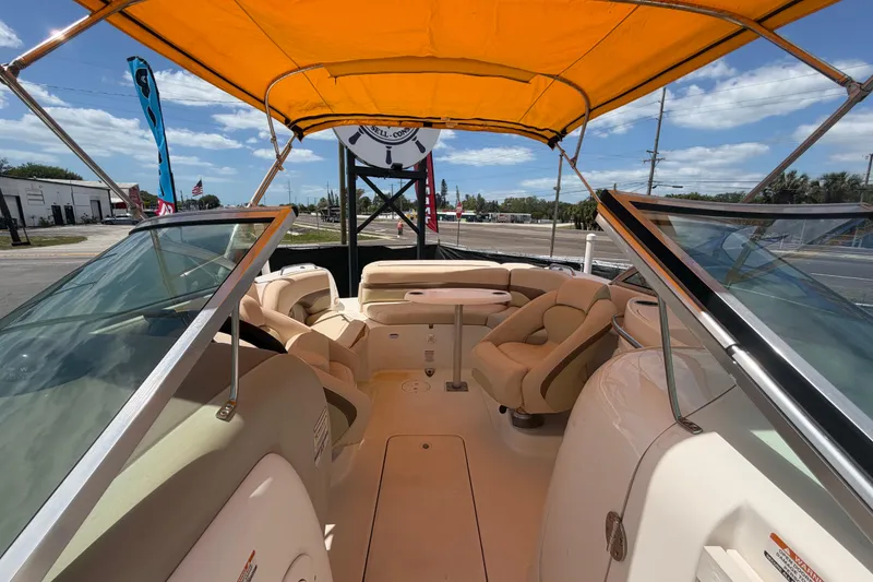 Slide: The Image of 2006 Chaparral Sunesta 236 boat interior with yellow canopy and comfortable seating. - 73