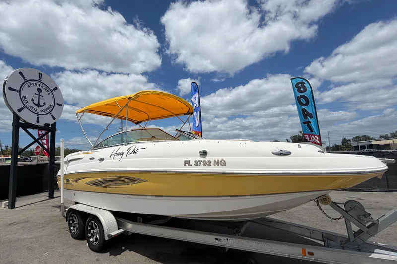 The Image of 2006 Chaparral Sunesta 236 boat with yellow canopy on trailer, displayed for sale. - 0