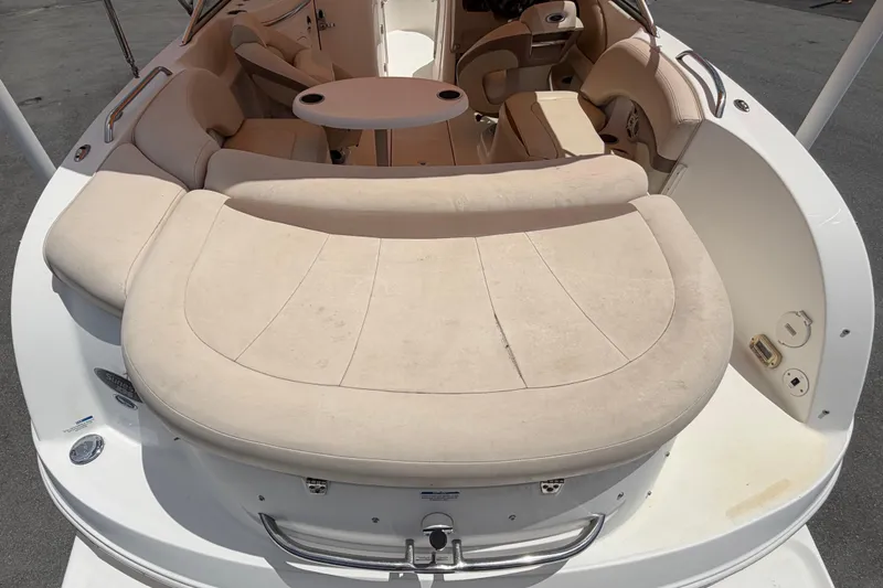 Slide: The Image of 2006 Chaparral Sunesta 236 boat interior with beige seating and round table. - 17