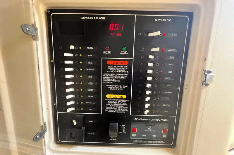 Slide: The Image of Electrical control panel on a 2006 Grady-White Express 330 boat, featuring AC and DC switches. - 26