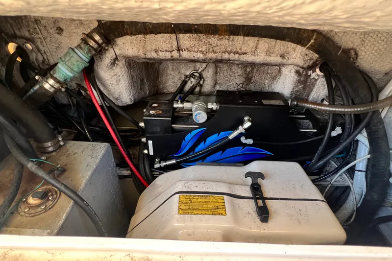 Slide: The Image of Engine compartment of a 2006 Grady-White Express 330 boat, showing mechanical components and wiring. - 69