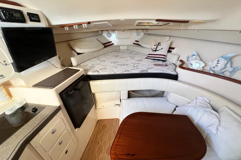 Slide: The Image of Luxurious 2006 Grady-White Express 330 cabin interior with cozy bed, kitchenette, and seating area. - 28