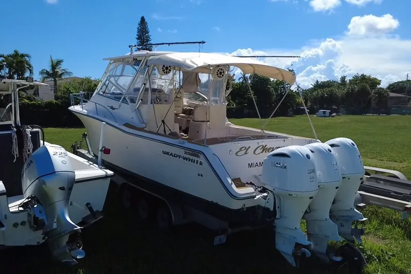 Slide: The Image of 2006 Grady-White Express 330 boat with triple outboard engines on a trailer. - 17