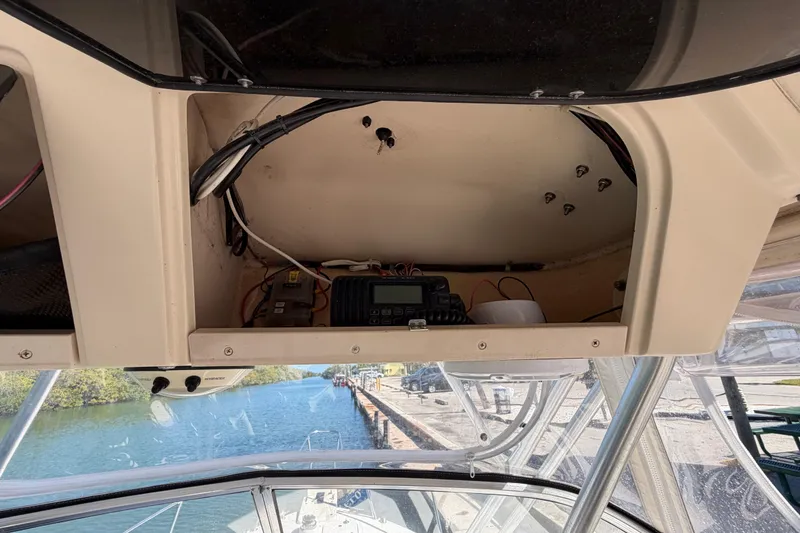Slide: The Image of 2006 Grady-White Sailfish 282 boat interior with electronic equipment and waterway view. - 107
