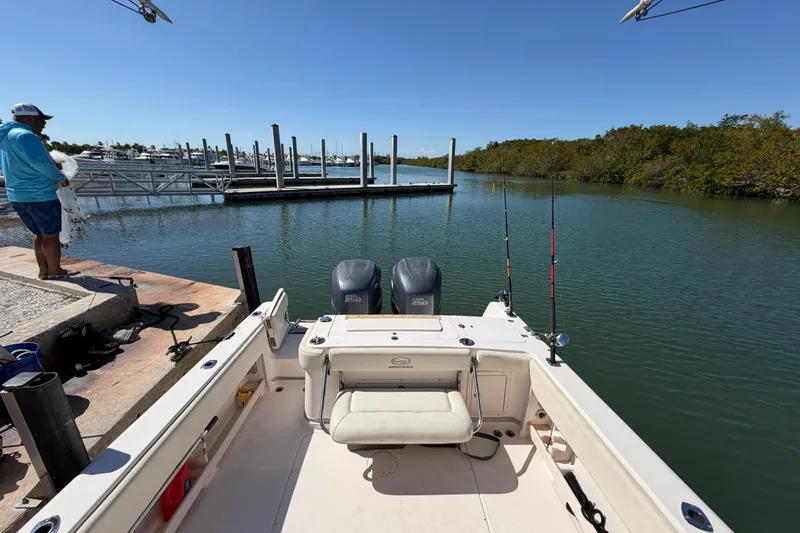 Slide: The Image of 2006 Grady-White Sailfish 282 at dock, fishing rods ready, calm waters. - 105