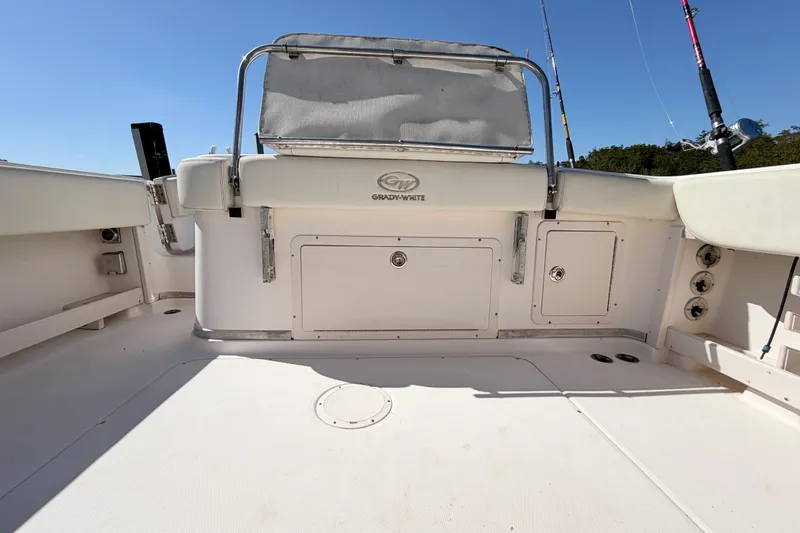 Slide: The Image of 2006 Grady-White Sailfish 282 boat deck with fishing rods and storage compartments. - 196