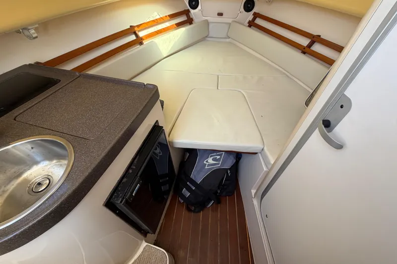Slide: The Image of 2006 Grady-White Sailfish 282 cabin interior with kitchenette and seating area. - 162
