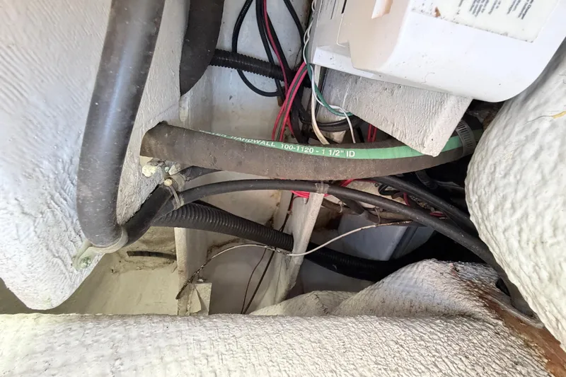 Slide: The Image of 2006 Grady-White Sailfish 282 boat wiring and hoses in engine compartment. - 203