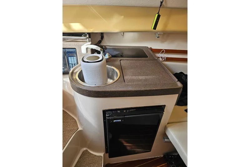 Slide: The Image of 2006 Grady-White Sailfish 282 boat interior with sink, countertop, and mini fridge. - 16