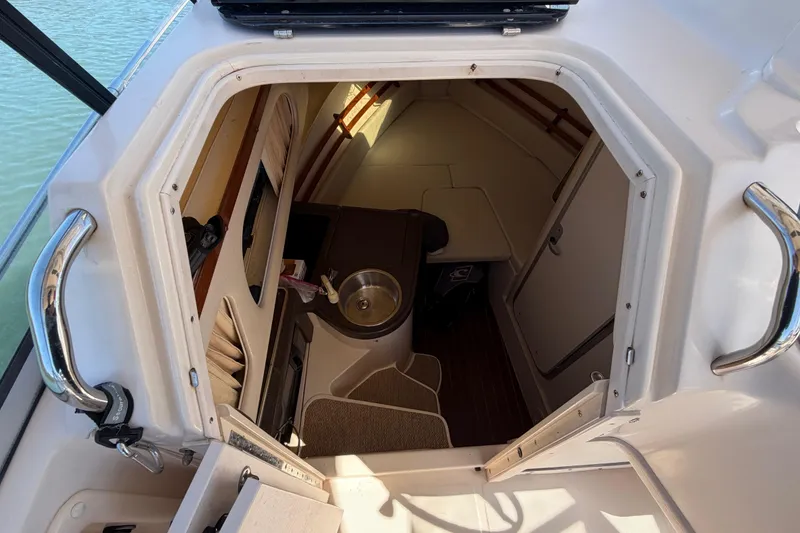 Slide: The Image of 2006 Grady-White Sailfish 282 cabin interior with sink and seating area. - 115
