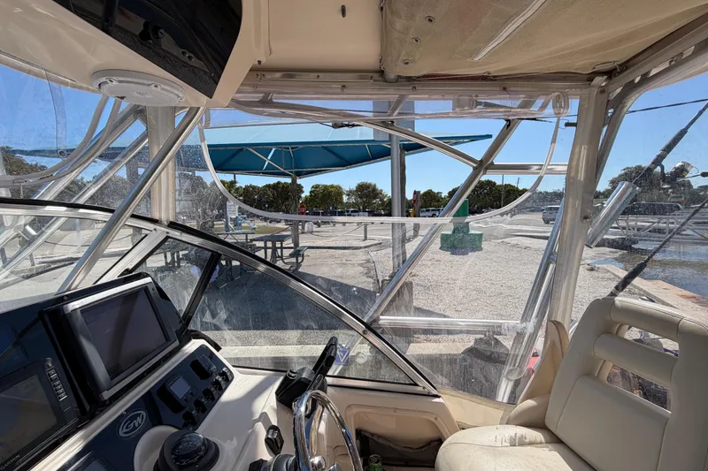 Slide: The Image of Interior view of 2006 Grady-White Sailfish 282 boat with clear canopy and control panel. - 99
