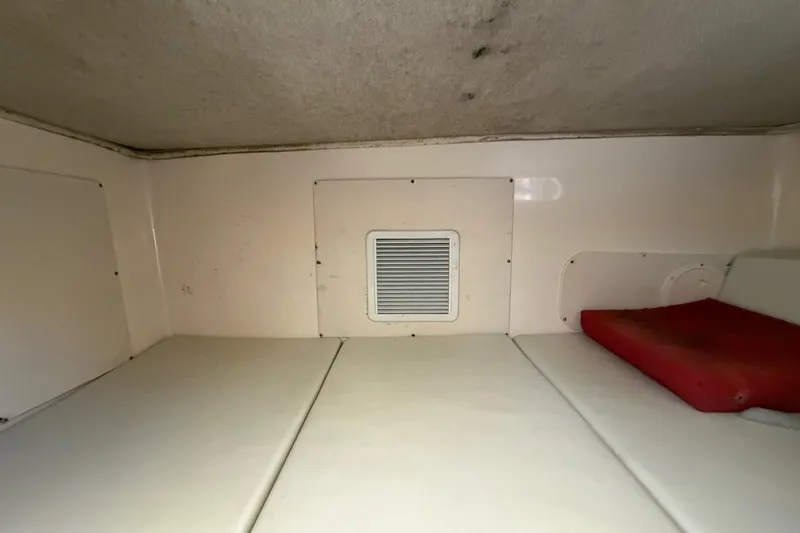 Slide: The Image of 2006 Grady-White Sailfish 282 cabin interior with vent and red cushion. - 150