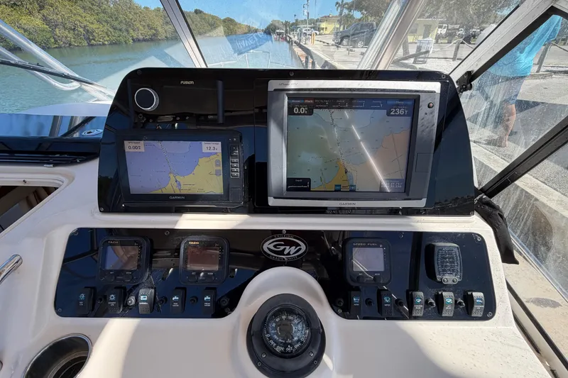 Slide: The Image of Dashboard of a 2006 Grady-White Sailfish 282 with navigation screens and controls. - 97