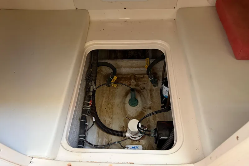 Slide: The Image of 2006 Grady-White Sailfish 282 interior compartment with visible wiring and components. - 152