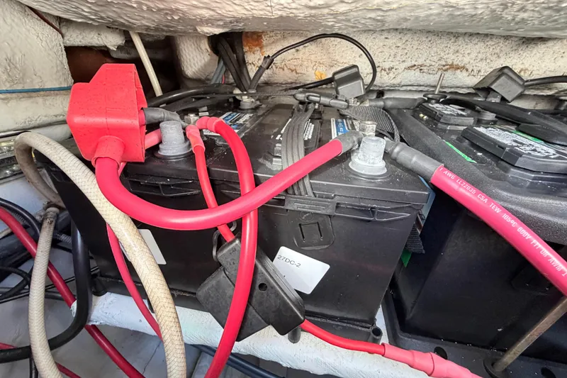 Slide: The Image of Battery compartment of 2006 Grady-White Sailfish 282 with red cables and connectors. - 193