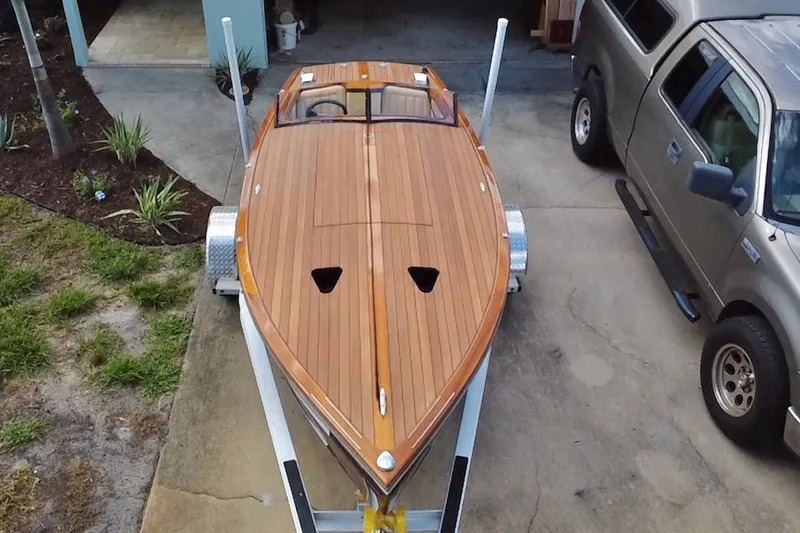 Slide: The Image of Custom Line 17 boat, 2025 model, on trailer beside a parked truck. - 2