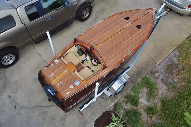 Slide: The Image of Aerial view of a 2025 Custom Line 17 wooden boat on a trailer. - 6