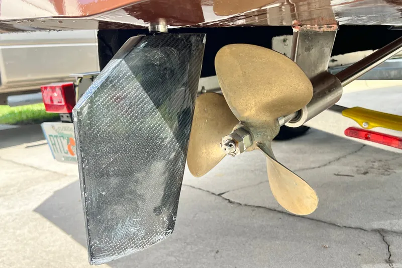 Slide: The Image of Close-up of a 2025 Custom Line 17 boat propeller and rudder on a trailer. - 38