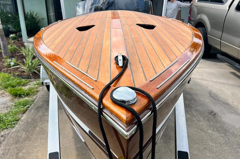 Slide: The Image of Custom Line 17 boat, 2025 model, featuring sleek wooden deck design on trailer. - 48