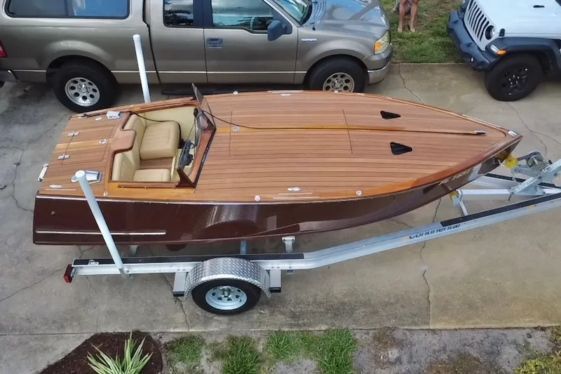 Slide: The Image of Custom Line 17 boat, 2025 model, on trailer with wooden deck and beige interior. - 5